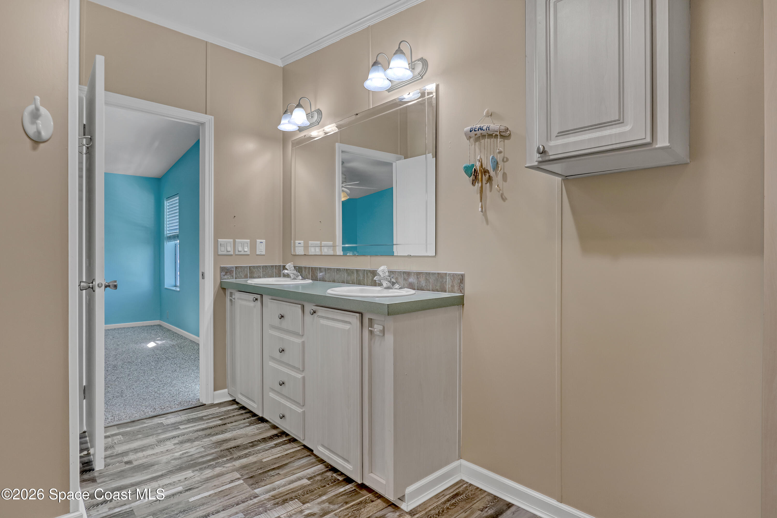 7547 Boxelder Road Micco, FL 32976 - Photo 28 of 53 a bathroom with a sink a mirror and a shower