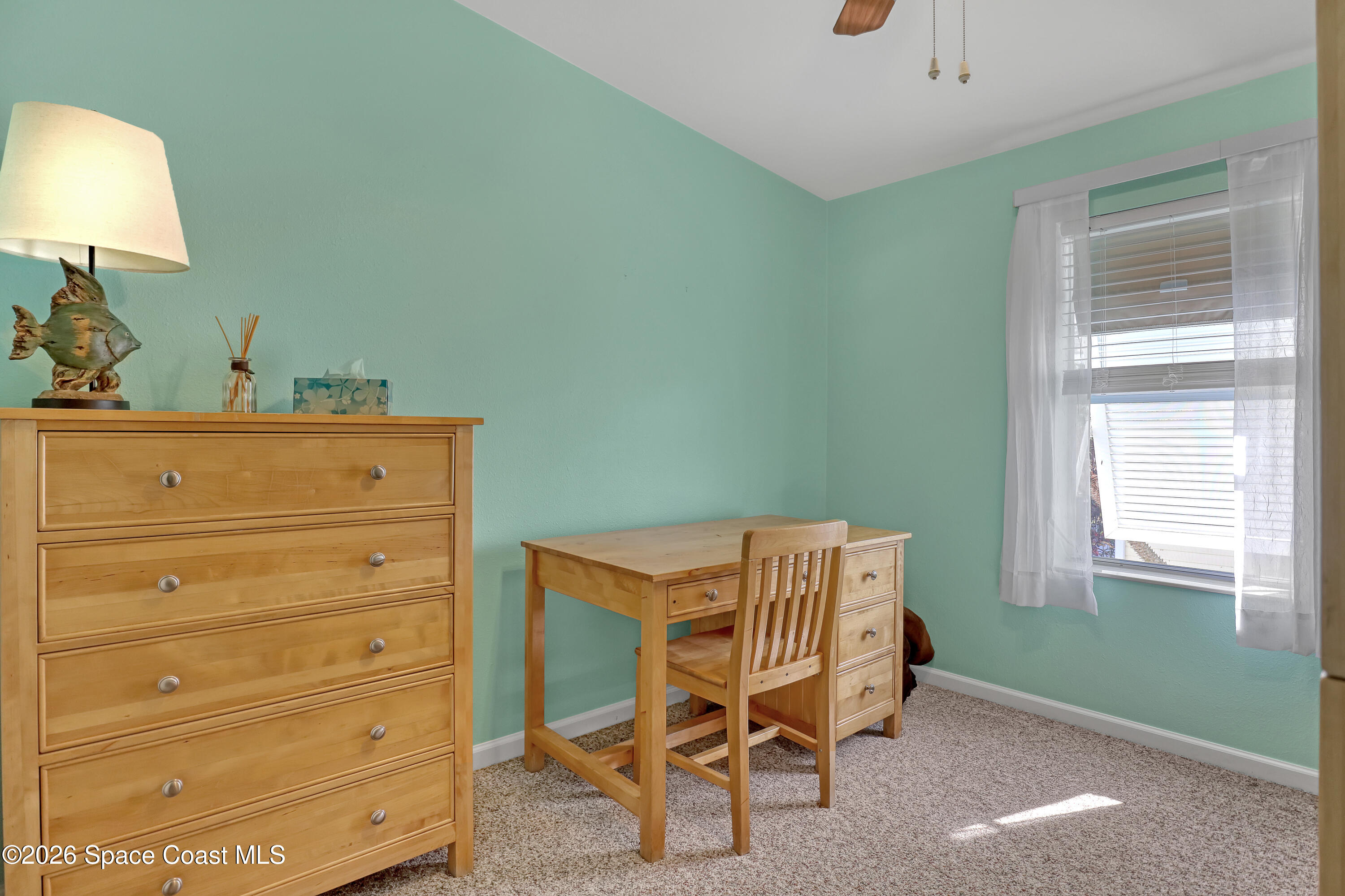 7547 Boxelder Road Micco, FL 32976 - Photo 29 of 53 a room with furniture and a window