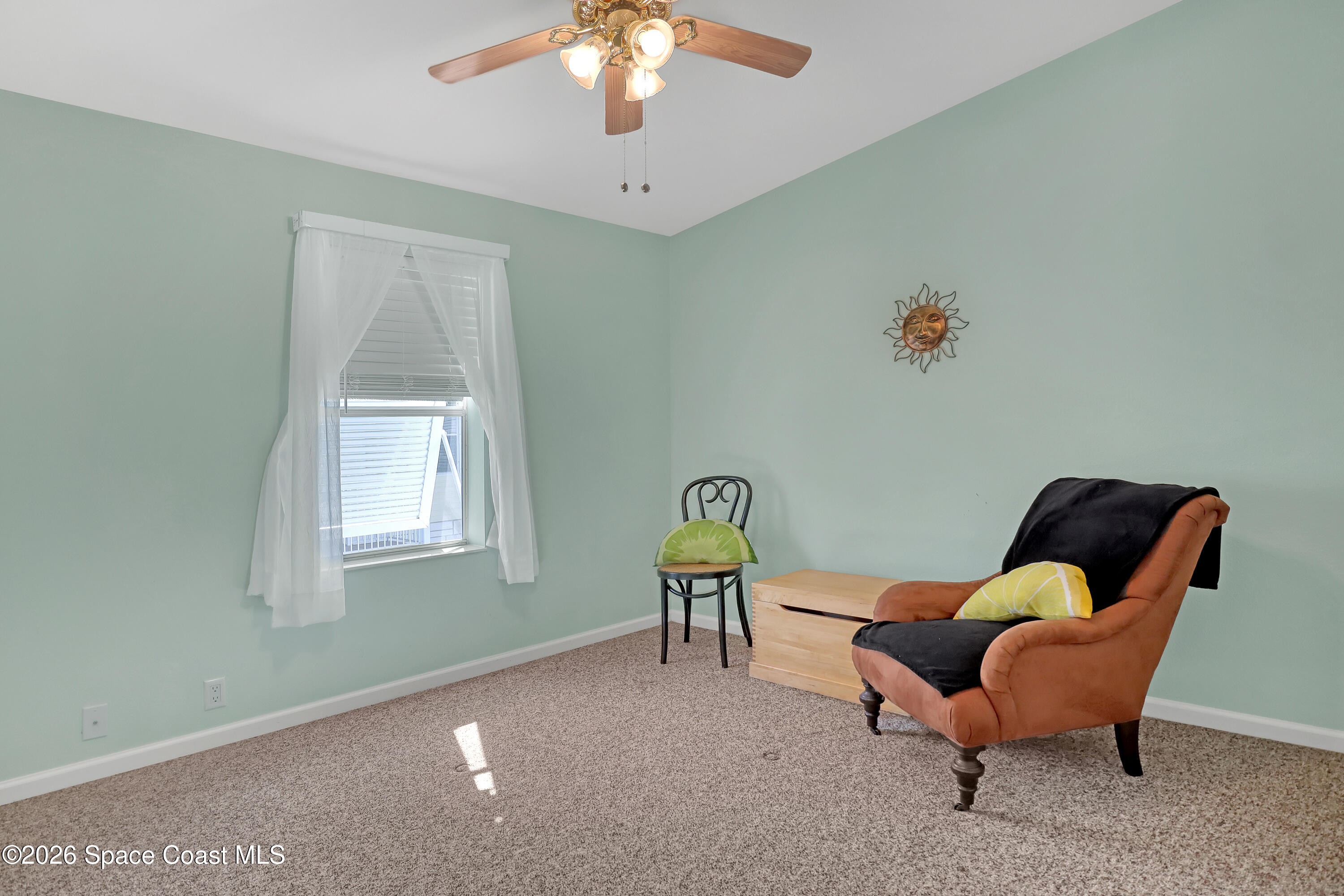 7547 Boxelder Road Micco, FL 32976 - Photo 32 of 53 a living room with furniture and a window