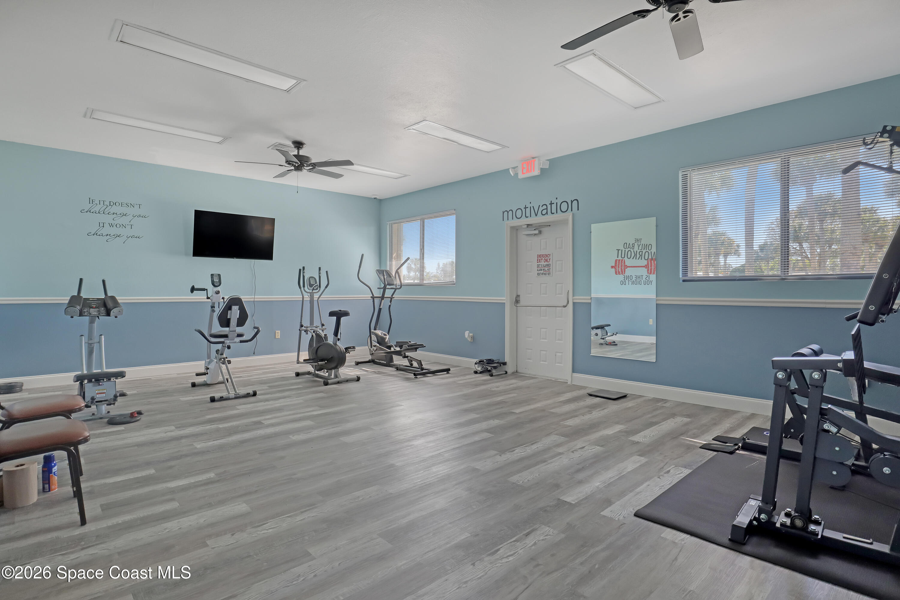 7547 Boxelder Road Micco, FL 32976 - Photo 44 of 53 a room with gym equipment and a flat screen tv