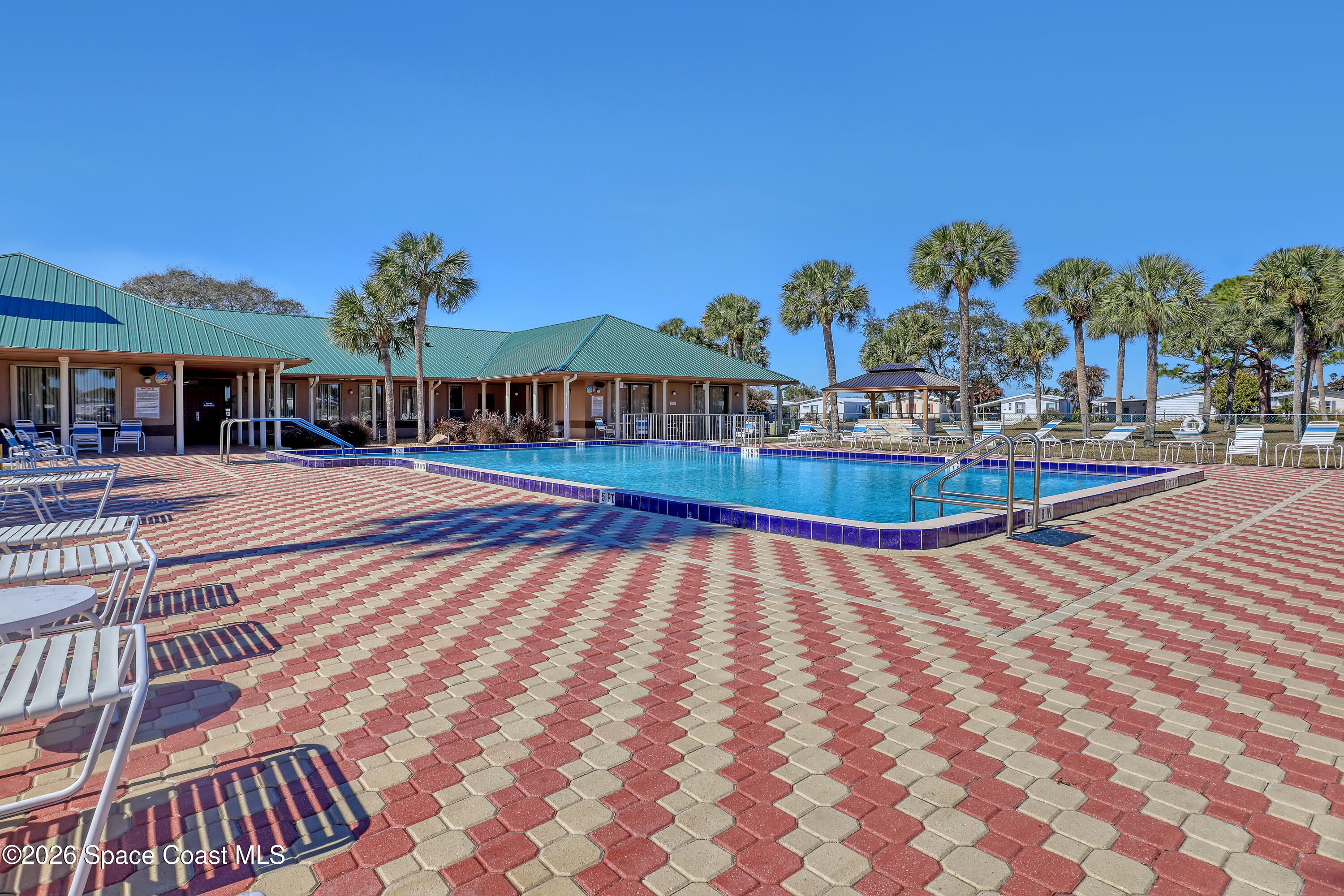 7547 Boxelder Road Micco, FL 32976 - Photo 47 of 53 a view of a swimming pool with an outdoor seating