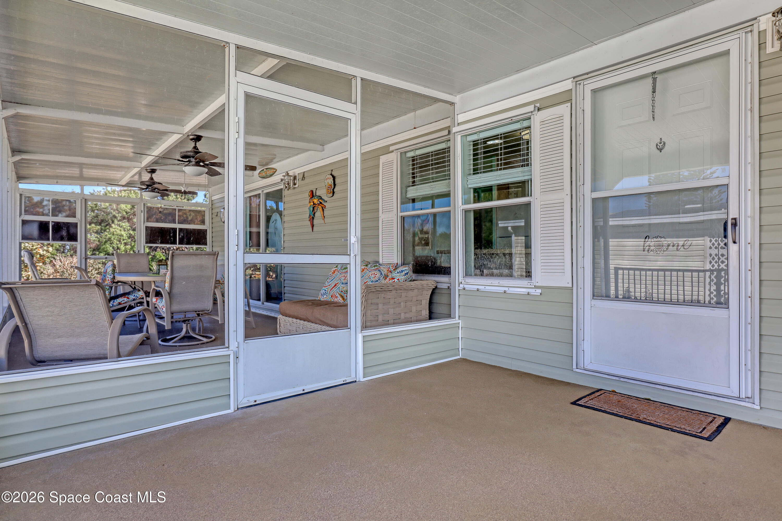 7547 Boxelder Road Micco, FL 32976 - Photo 5 of 53 an empty room with wooden floor and windows
