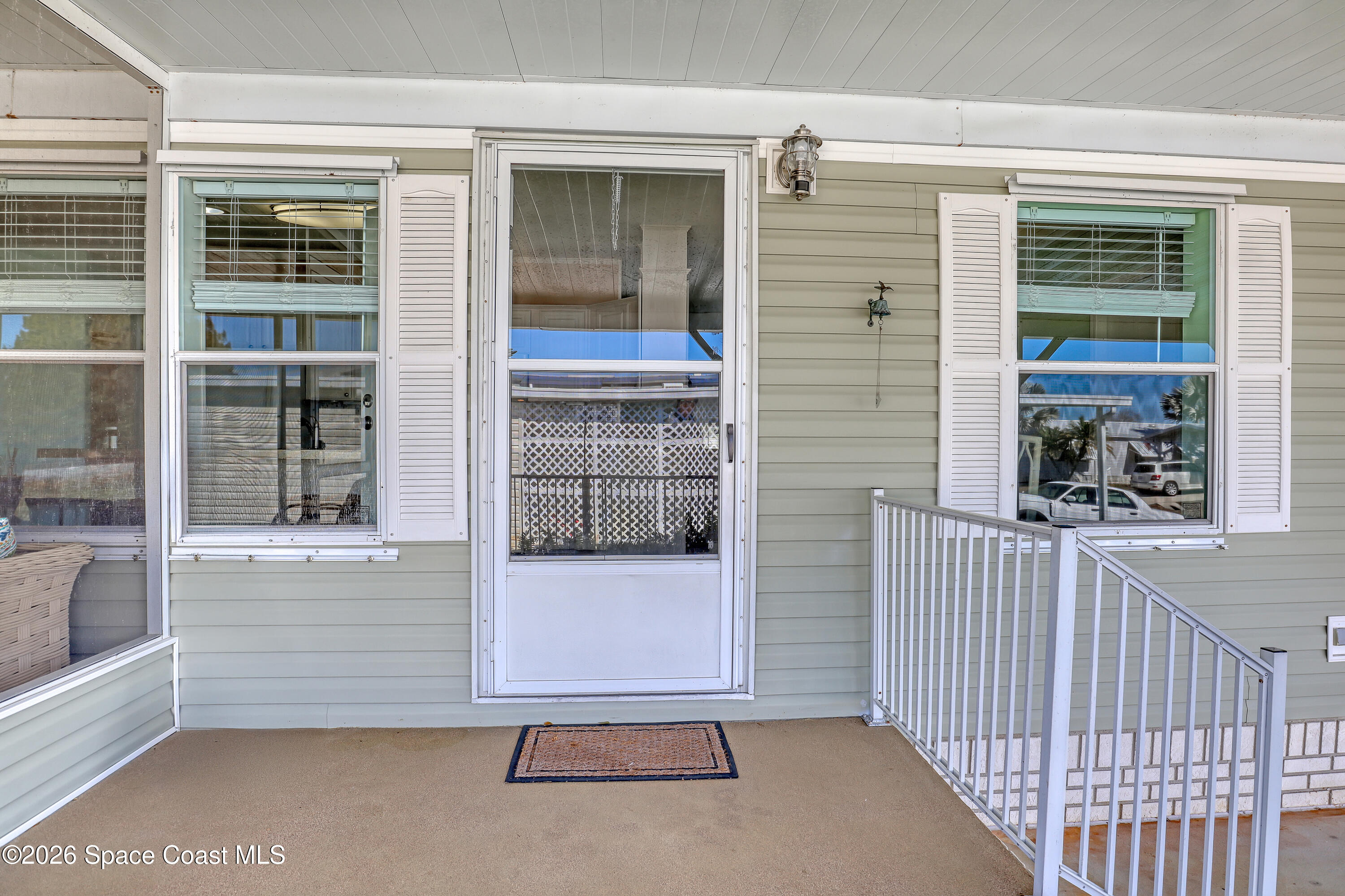 7547 Boxelder Road Micco, FL 32976 - Photo 6 of 53 front view of the house with a glass door