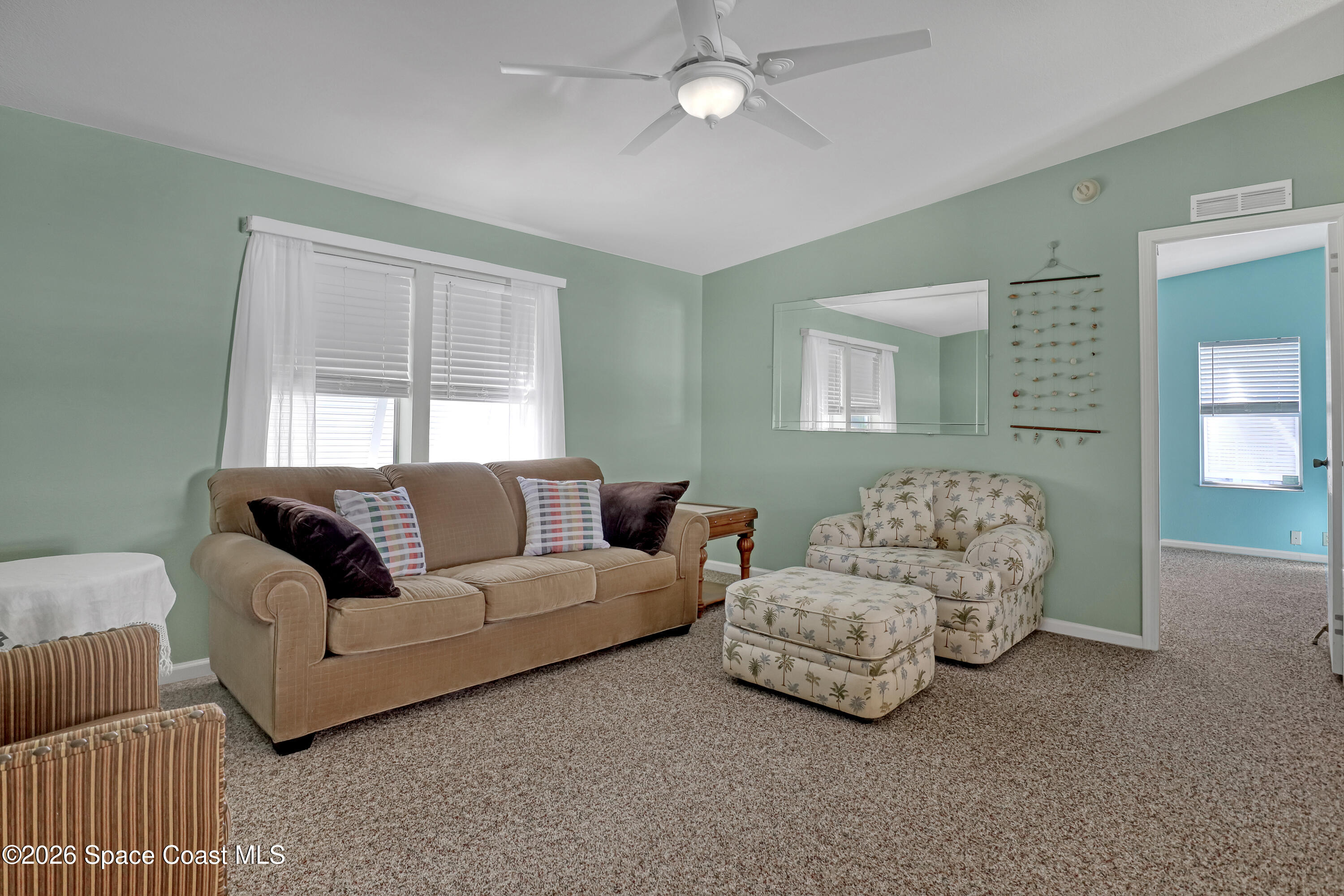 7547 Boxelder Road Micco, FL 32976 - Photo 10 of 53 a living room with couches and painted walls