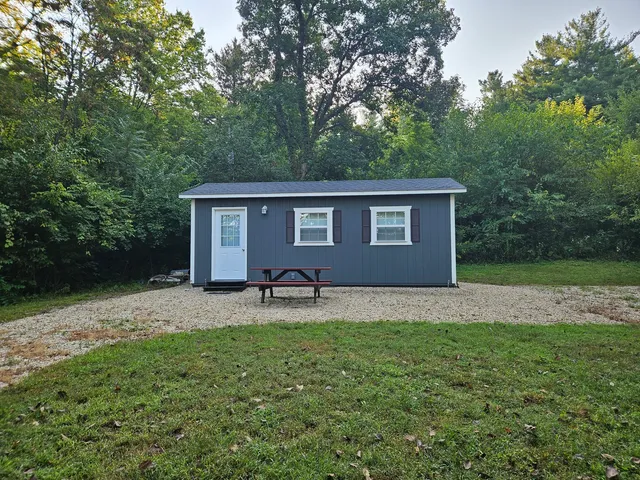 a backyard of a house with yard barbeque oven and outdoor seating