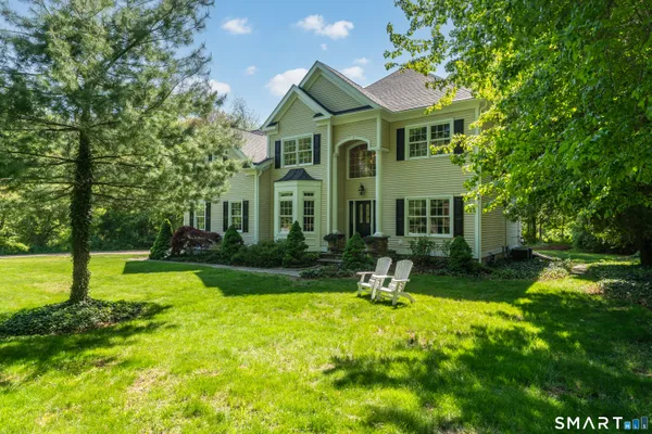 a front view of a house with garden and porch