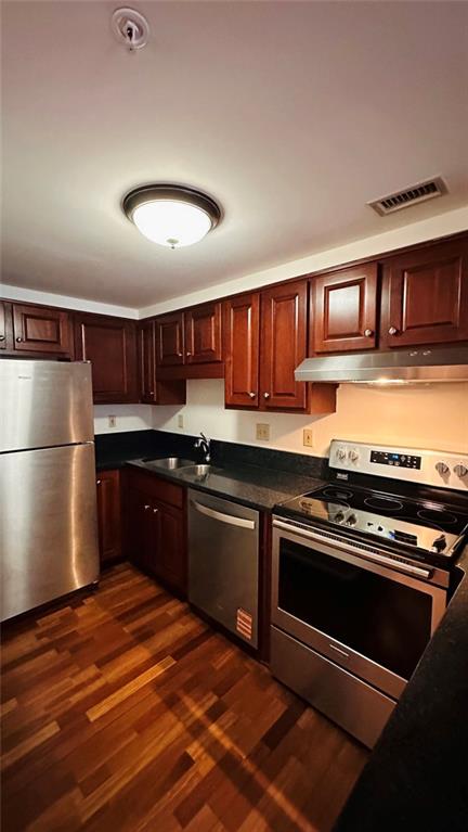 199 14th Street Northeast, Unit 507 Atlanta, GA 30309 - Photo 18 of 26 a kitchen with stainless steel appliances granite countertop a stove and a refrigerator
