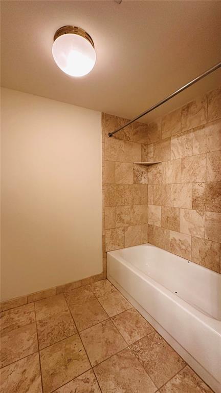 199 14th Street Northeast, Unit 507 Atlanta, GA 30309 - Photo 23 of 26 a bathroom with a bathtub and a shower