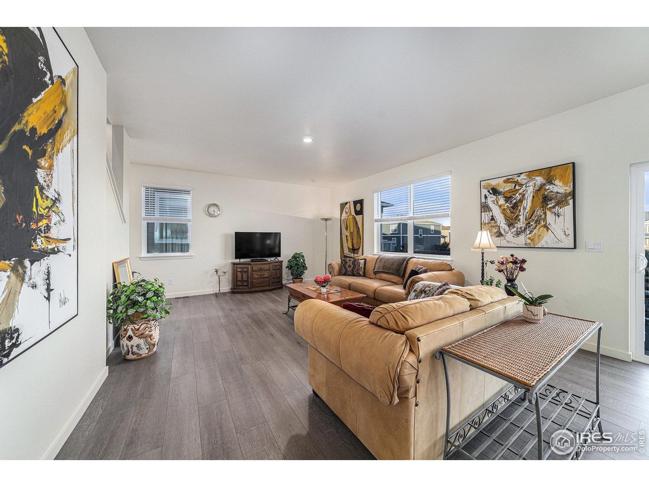 439 Bluebird Road Johnstown, CO 80534 - Photo 18 of 37 a living room with furniture and a flat screen tv