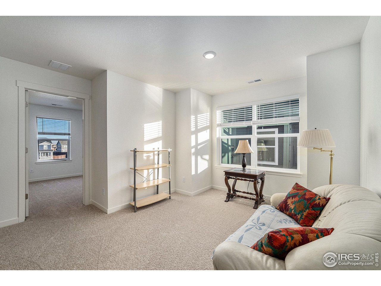 439 Bluebird Road Johnstown, CO 80534 - Photo 24 of 37 a living room with furniture and a window