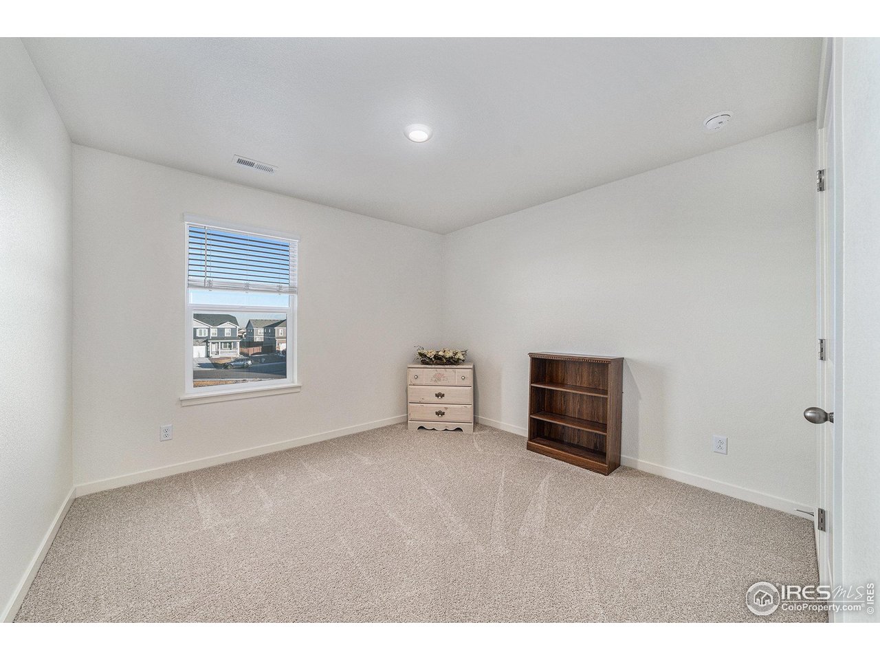439 Bluebird Road Johnstown, CO 80534 - Photo 27 of 37 a view of an empty room with a window