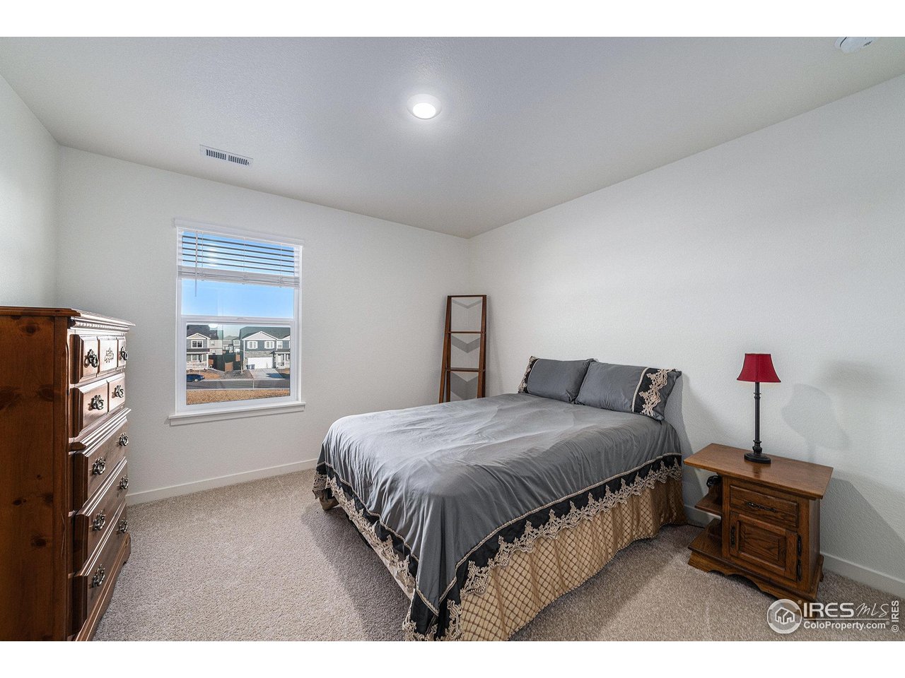 439 Bluebird Road Johnstown, CO 80534 - Photo 28 of 37 a bedroom with a bed window and a night stand