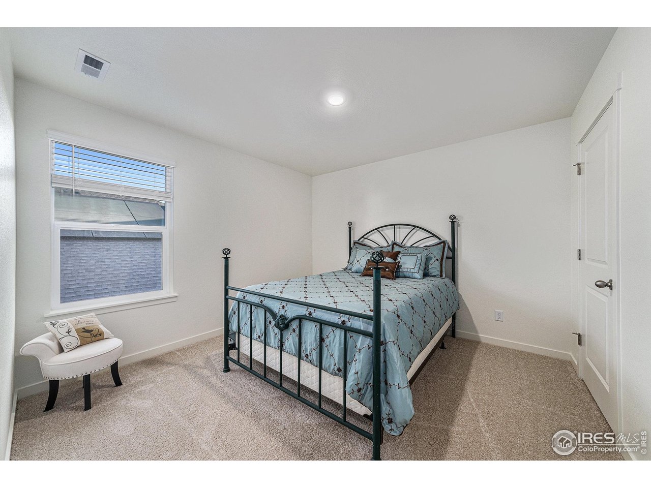 439 Bluebird Road Johnstown, CO 80534 - Photo 29 of 37 a bedroom with a bed and window