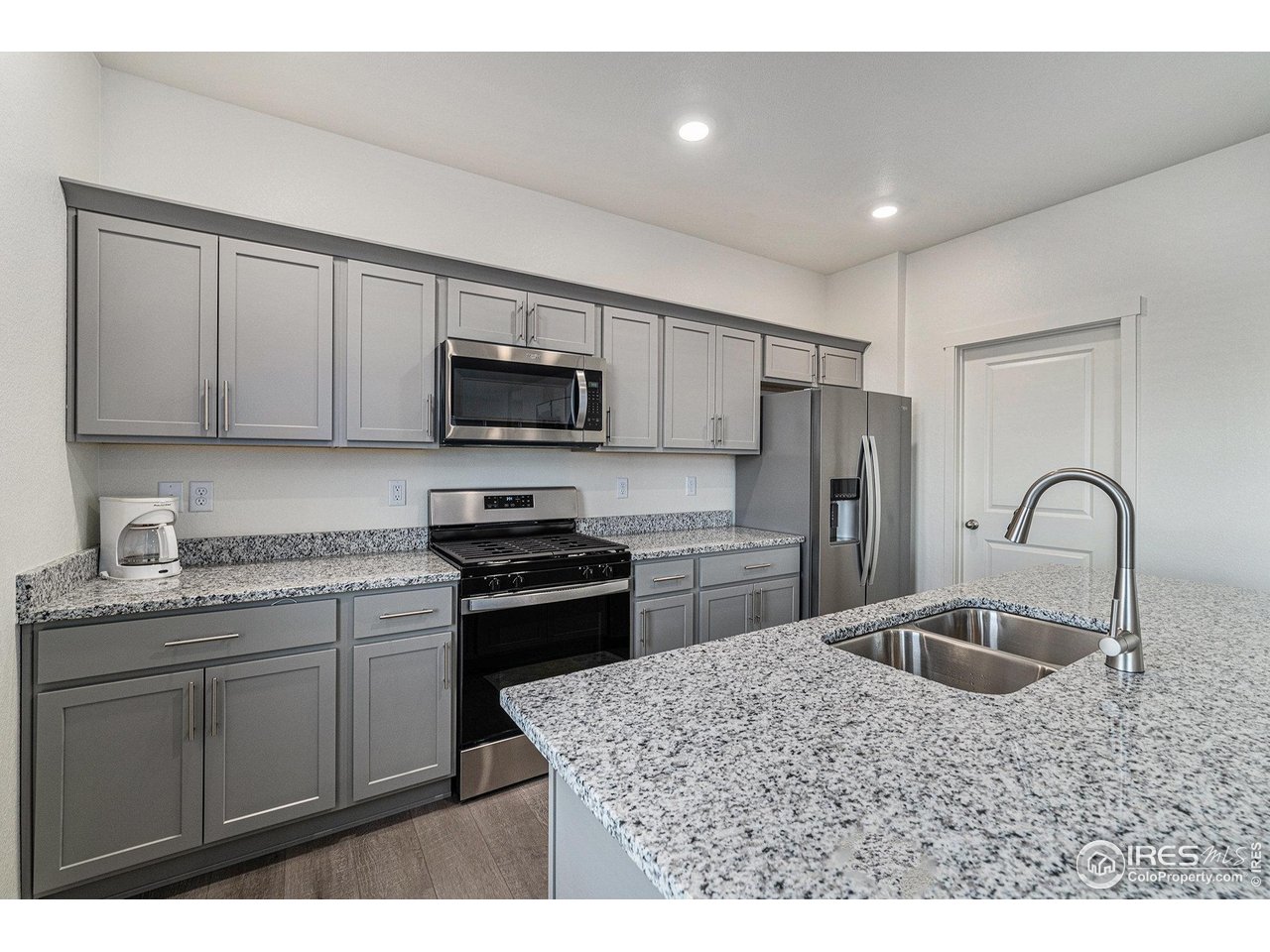 439 Bluebird Road Johnstown, CO 80534 - Photo 10 of 37 a kitchen with kitchen island a sink stainless steel appliances and a counter top