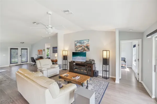 a living room with furniture and a wooden floor