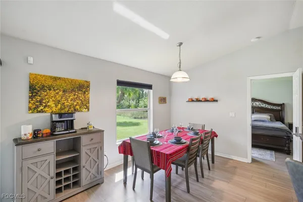 a view of a dining room with furniture window and wooden floor
