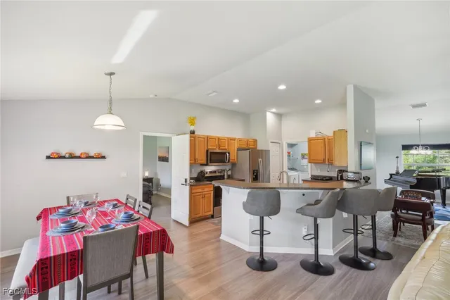 a bedroom with a bed a chandelier and a flat tv