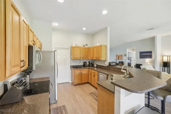 a kitchen with a sink stove top oven and microwave