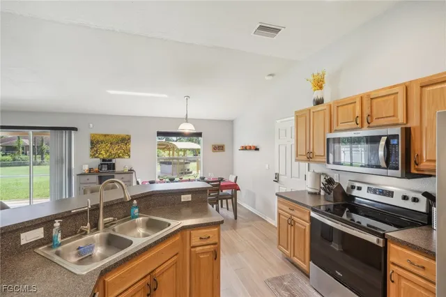 a bedroom with a bed and a flat tv screen on a table