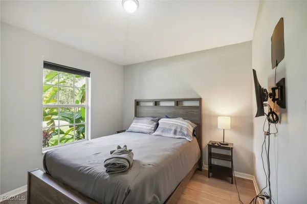 a bedroom with a large bed and a large window