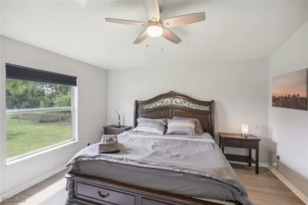 a bathroom with a bathtub shower sink vanity and mirror