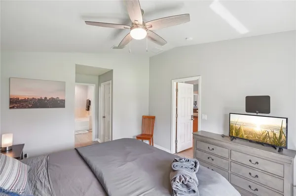 a view of a bedroom with a bed and a window