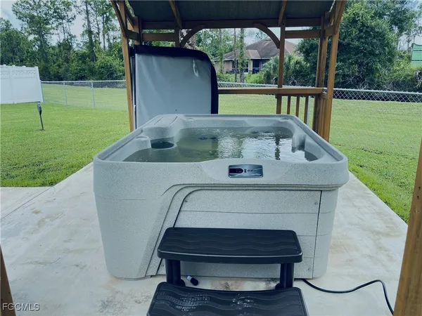 a view of backyard with deck and outdoor seating