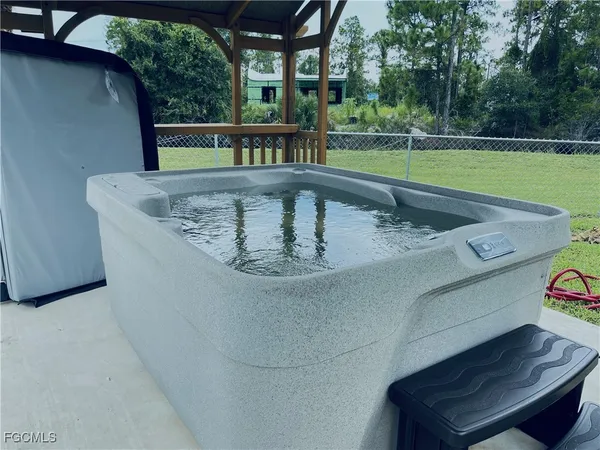 a view of a swimming pool with a yard from a balcony