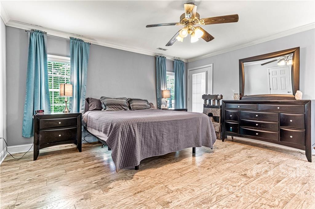 1776 Furnace Road Lincolnton, NC 28092 - Photo 17 of 41 a bedroom with a bed and a chandelier