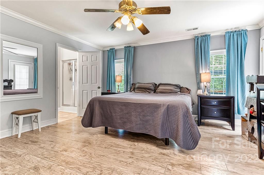 1776 Furnace Road Lincolnton, NC 28092 - Photo 18 of 41 a bedroom with a bed and a chandelier