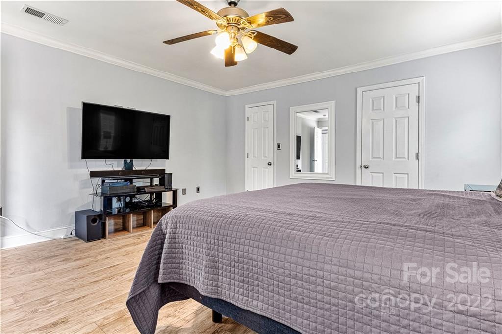 1776 Furnace Road Lincolnton, NC 28092 - Photo 19 of 41 a bedroom with a bed and a flat screen tv