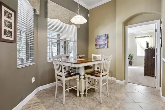 a view of a dining room with furniture and a window