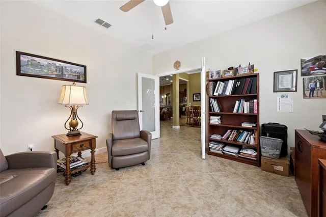 a living room with furniture and a book shelf