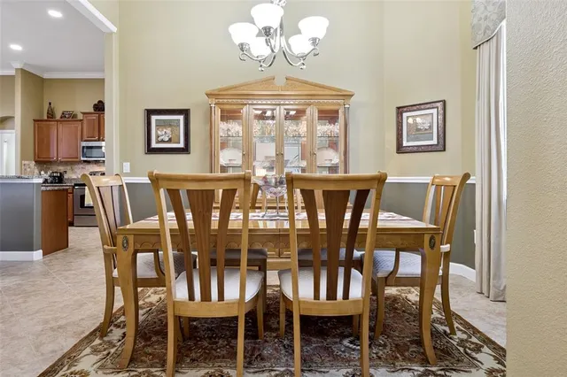 a view of a dining room with furniture wooden floor and chandelier