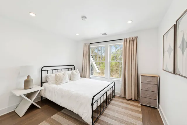 a bedroom with a bed and a large window