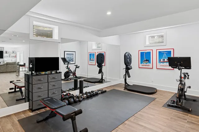 a room with gym equipment and a flat screen tv