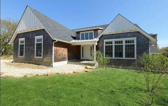 a front view of a house with a yard and porch