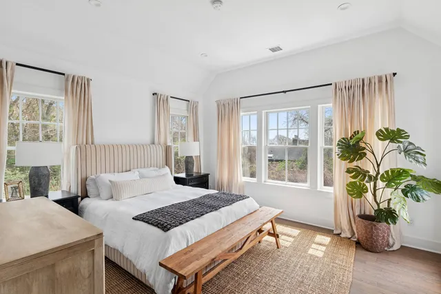 a bedroom with a bed a table and chair