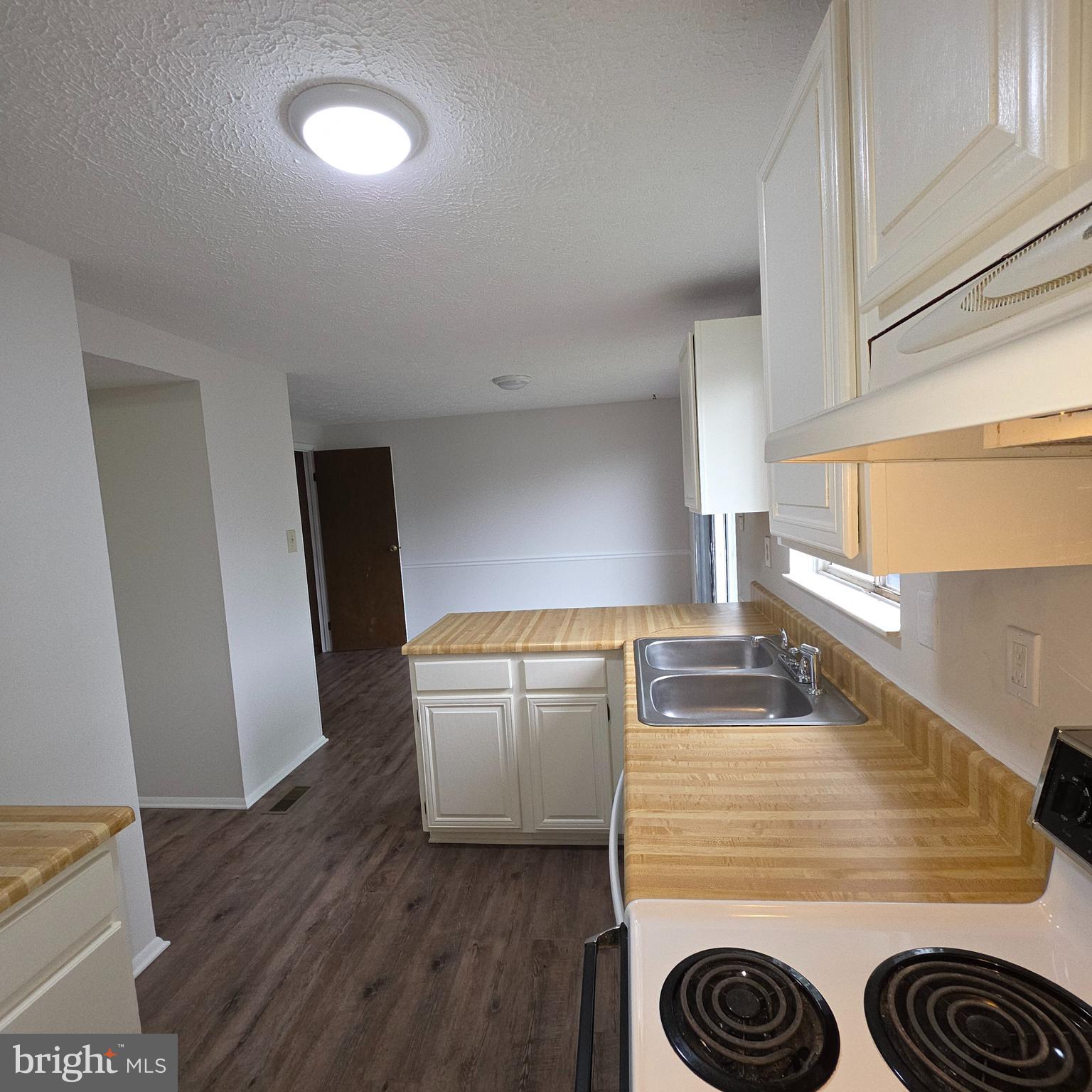 1758 Springfield Lane Frederick, MD 21702 - Photo 8 of 31 a kitchen with a refrigerator and a stove top oven