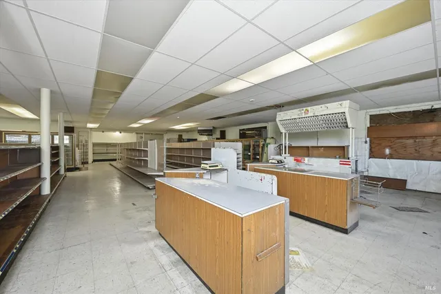 a utility room with stainless steel appliances kitchen island granite countertop lots of counter space