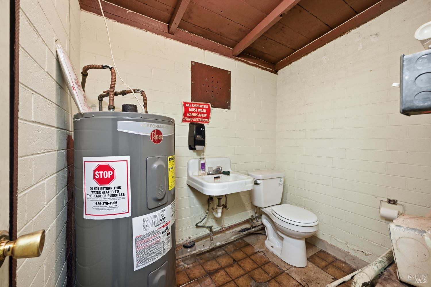 3794 Highway 20 Nice, CA 95464 - Photo 26 of 36 a bathroom with a toilet sink vanity and mirror
