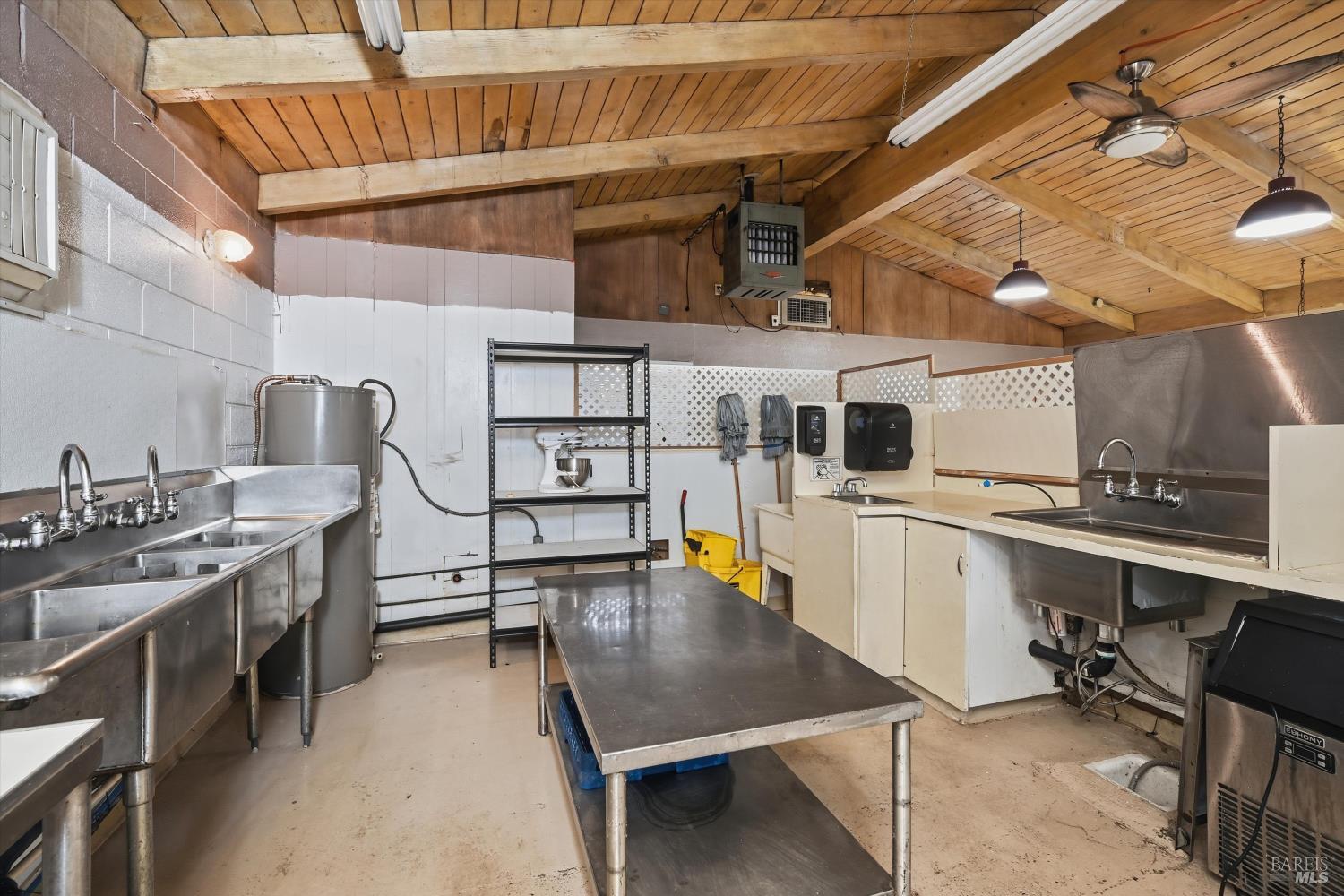 3794 Highway 20 Nice, CA 95464 - Photo 31 of 36 a room with wooden cabinets and stainless steel appliances