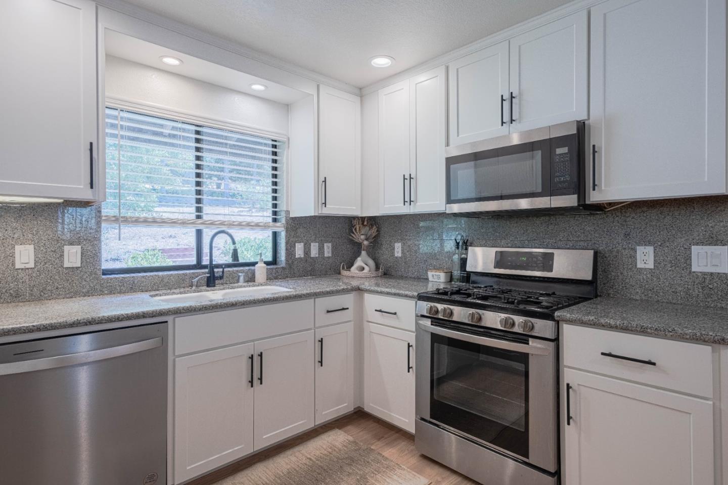 5240 Strong Circle Watsonville, CA 95076 - Photo 20 of 51 a kitchen with white cabinets and appliances