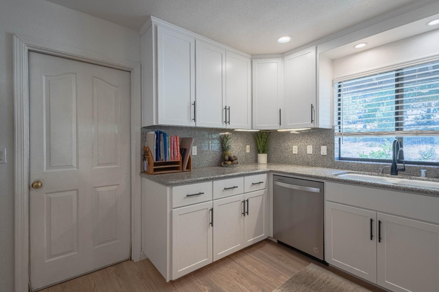 5240 Strong Circle Watsonville, CA 95076 - Photo 21 of 51 a kitchen with white cabinets and white appliances
