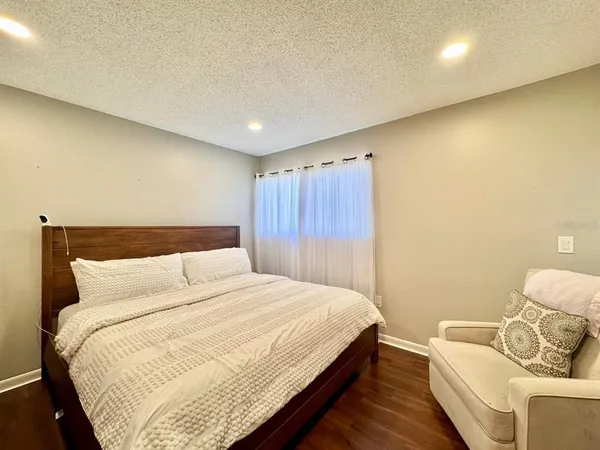 a bedroom with a bed and couch