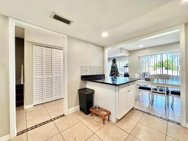 a kitchen with granite countertop a sink and cabinets
