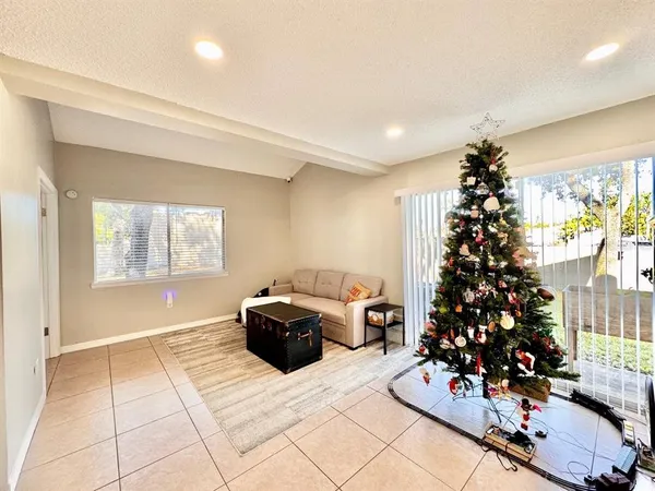a living room with furniture flowers and a window
