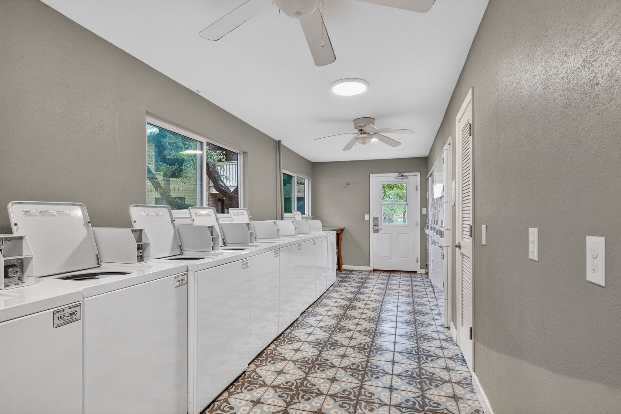 8210 Bent Tree Road, Unit 256 Austin, TX 78759 - Photo 24 of 29 a large white kitchen with a sink and a large window