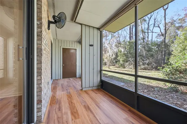 a view of a room with wooden floor and a porch