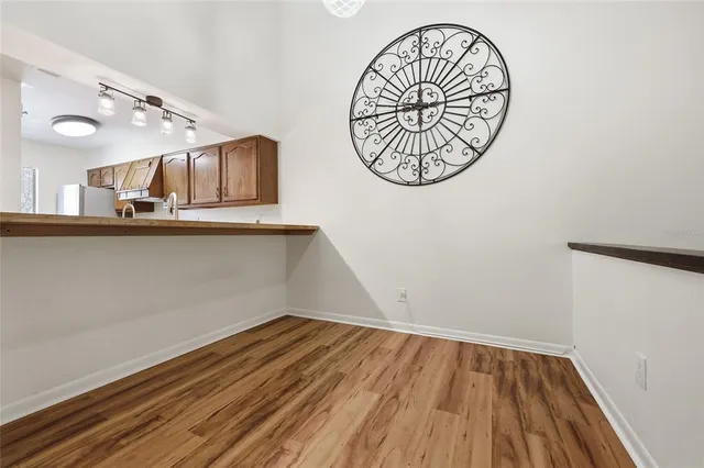 a view of a room with wooden floor and windows